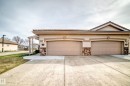 Stucco exterior with a tiled roofline and stone veneer accents - 40 13808 155 Avenue, Edmonton, AB  - Outdoor 