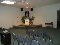 Carpeted room featuring a raised platform with a podium - 