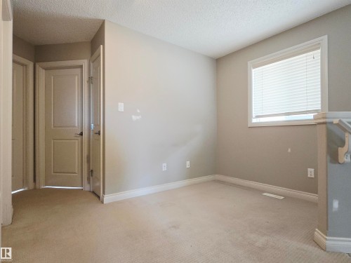 Carpeted room featuring a single window with blinds, baseboard trim, and neutral wall tones - 21321 94 Avenue, Edmonton, AB - Indoor Photo Showing Other Room