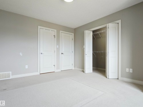 Neutral-toned room featuring light gray walls, white trim, and light-colored carpeting - 21321 94 Avenue, Edmonton, AB - Indoor