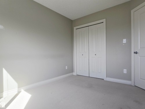 Room featuring light gray walls, white trim, and light-colored carpet flooring - 21321 94 Avenue, Edmonton, AB - Indoor Photo Showing Other Room