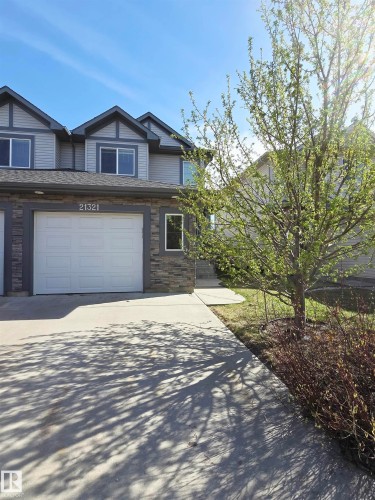 Contemporary exterior featuring light grey siding, dark grey trim, and stone accents - 21321 94 Avenue, Edmonton, AB - Outdoor