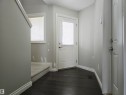 Entryway featuring dark laminate flooring, light gray walls, and white baseboards - 21321 94 Avenue, Edmonton, AB  - Indoor Photo Showing Other Room 