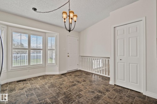 Expansive bay window featuring white blinds - 18903 70 Avenue, Edmonton, AB - Indoor Photo Showing Other Room