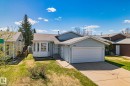 Light blue siding exterior with an attached garage and a concrete driveway - 18903 70 Avenue, Edmonton, AB  - Outdoor 