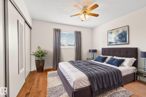 Hardwood-finish flooring complementing light-toned walls - 18903 70 Avenue, Edmonton, AB - Indoor Photo Showing Bedroom