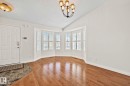 Bay window with multiple panels, wood-finish flooring, and a tiled entryway - 18903 70 Avenue, Edmonton, AB  - Indoor Photo Showing Other Room 