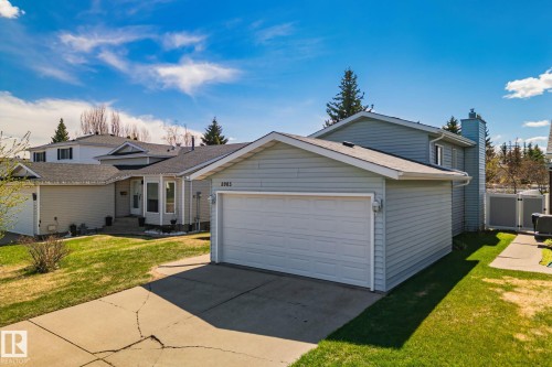 Single-family residence featuring light blue siding, an attached garage, and a concrete driveway - 18903 70 Avenue, Edmonton, AB - Outdoor