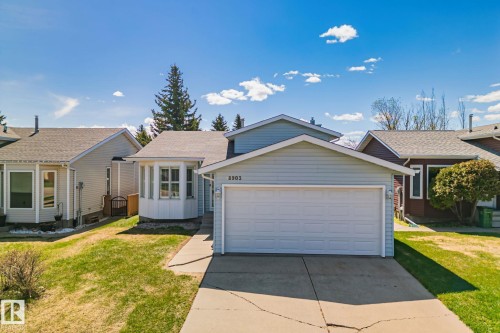 Light blue siding exterior with a white garage door - 18903 70 Avenue, Edmonton, AB - Outdoor