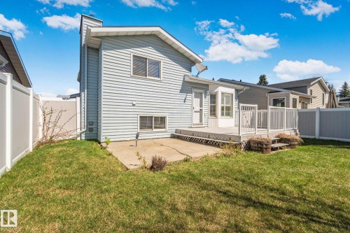 Rear exterior with light blue horizontal siding and a white trim - 18903 70 Avenue, Edmonton, AB - Outdoor