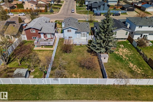 Expansive property featuring a vinyl privacy fence, mature trees, a detached storage shed, and a verdant lawn - 18903 70 Avenue, Edmonton, AB - Outdoor