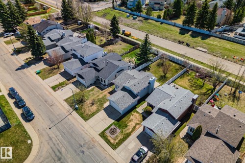 Aerial perspective showcasing a residential street lined with single-family homes, each featuring a private driveway and attached garage - 18903 70 Avenue, Edmonton, AB - Outdoor With View