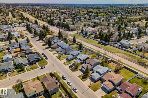 Aerial overview of a residential neighborhood featuring established streets, single-family homes, and mature trees - 18903 70 Avenue, Edmonton, AB - Outdoor With View