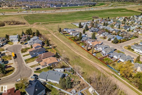 Residential neighborhood with individual properties featuring fenced yards and asphalt shingle roofs - 18903 70 Avenue, Edmonton, AB - Outdoor With View