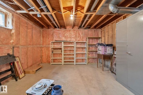 Unfinished basement space with exposed wood joists and subfloor ceiling - 18903 70 Avenue, Edmonton, AB - Indoor Photo Showing Basement