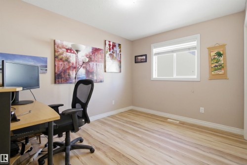 Light-toned wood-finish flooring complements neutral wall tones - 16204 48 Street, Edmonton, AB - Indoor Photo Showing Office