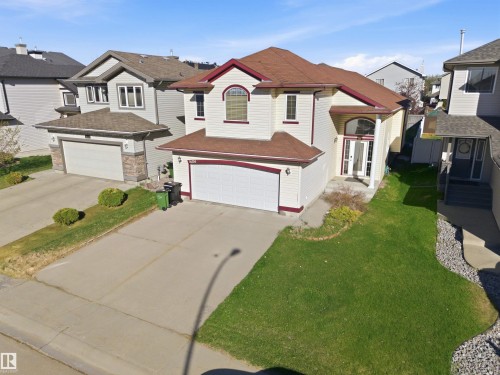 Two-story residence featuring a two-car garage, prominent arched entry, and a contrasting roofline - 16204 48 Street, Edmonton, AB - Outdoor