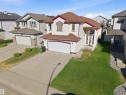 Two-story residence featuring a two-car garage, prominent arched entry, and a contrasting roofline - 16204 48 Street, Edmonton, AB  - Outdoor 