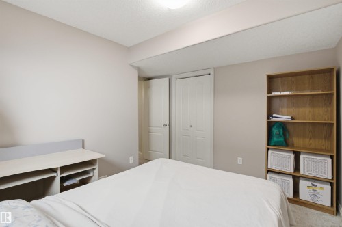 Neutral wall tones complement the ceiling-mounted light fixture - 16204 48 Street, Edmonton, AB - Indoor Photo Showing Bedroom