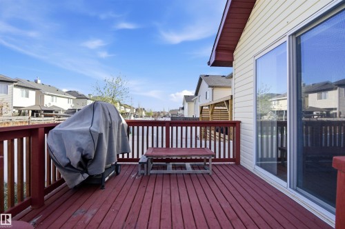 Spacious wooden deck featuring red-stained flooring and railing - 16204 48 Street, Edmonton, AB - Outdoor With Deck Patio Veranda With Exterior