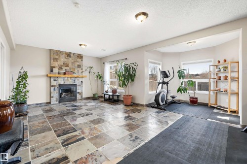 130 Foxhaven Way, Sherwood Park, AB - Indoor Photo Showing Gym Room With Fireplace