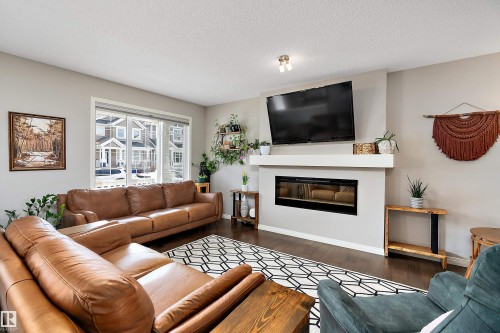 8324 23 Avenue, Edmonton, AB - Indoor Photo Showing Living Room With Fireplace