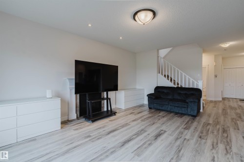 Open living area featuring light wood-finish flooring throughout - 17718 5A Avenue, Edmonton, AB - Indoor Photo Showing Living Room