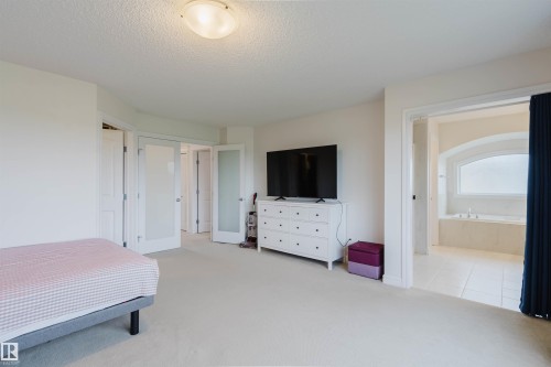 Carpeted bedroom with a built-in ceiling light fixture - 17718 5A Avenue, Edmonton, AB - Indoor Photo Showing Bedroom