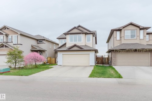 Two-story residence featuring light-colored siding with contrasting brown trim accents and a concrete driveway - 17718 5A Avenue, Edmonton, AB - Outdoor With Facade