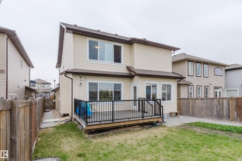 Rear exterior showcasing a two-story residence with light-colored siding - 17718 5A Avenue, Edmonton, AB - Outdoor With Exterior