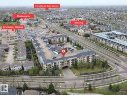 Aerial perspective highlighting the condominium building's proximity to diverse commercial establishments including grocery stores, medical facilities, restaurants, and banking services - 