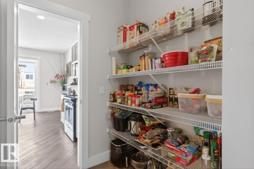 Kitchen pantry featuring wire shelving - 7942 Erasmus Crescent, Edmonton, AB - Indoor