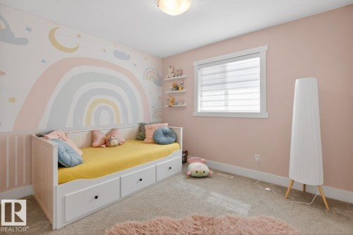 Wall-to-wall carpeting and neutral wall tones create a versatile space, complemented by a window with horizontal blinds and built-in wall shelving - 7942 Erasmus Crescent, Edmonton, AB - Indoor Photo Showing Bedroom