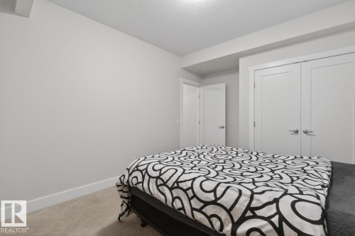 Room featuring light neutral wall paint and white trim - 7942 Erasmus Crescent, Edmonton, AB - Indoor Photo Showing Bedroom