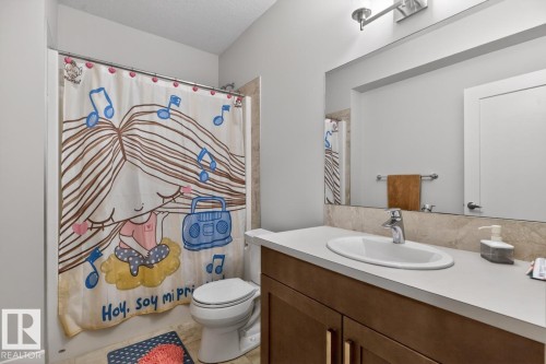 Bathroom featuring a vanity with a white countertop and brown cabinetry - 7942 Erasmus Crescent, Edmonton, AB - Indoor Photo Showing Bathroom