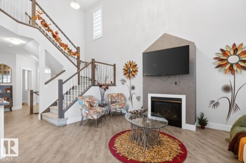 Two-story foyer with wood-finish flooring - 7942 Erasmus Crescent, Edmonton, AB - Indoor With Fireplace