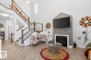 Two-story foyer with wood-finish flooring - 7942 Erasmus Crescent, Edmonton, AB  - Indoor With Fireplace 