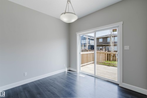 Expansive sliding glass doors opening to an outdoor deck area - 2839 Koshal Crescent, Edmonton, AB - Indoor Photo Showing Other Room