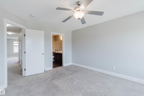Carpeted room with a ceiling fan, white baseboards, and light gray walls - 2839 Koshal Crescent, Edmonton, AB - Indoor Photo Showing Other Room