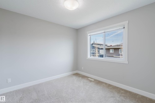 Light gray carpeting complements the neutral wall color - 2839 Koshal Crescent, Edmonton, AB - Indoor Photo Showing Other Room