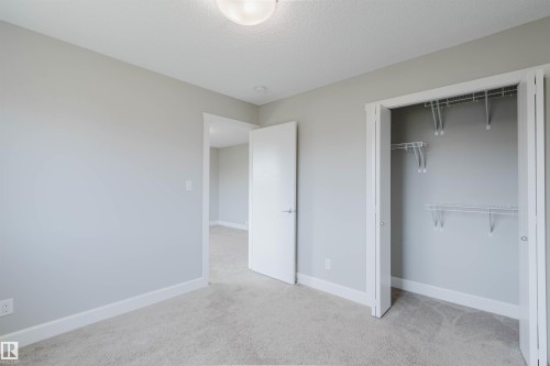 Interior room with light gray walls, light gray carpet flooring, and white baseboards - 2839 Koshal Crescent, Edmonton, AB - Indoor
