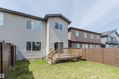Rear exterior with light gray horizontal siding and a wood deck - 2839 Koshal Crescent, Edmonton, AB - Outdoor With Deck Patio Veranda With Exterior