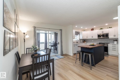 Open-concept living space featuring wood-finish flooring - 25 1904 Mill Woods Road Road, Edmonton, AB - Indoor