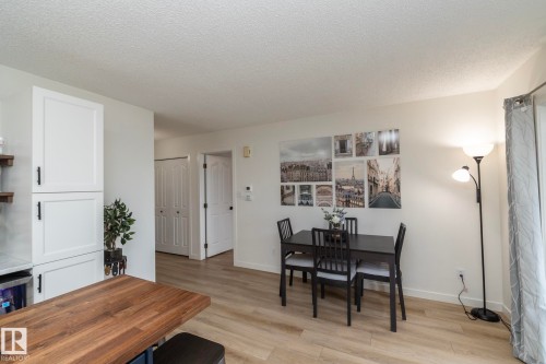 Light wood-finish flooring provides a neutral base for the dining area - 25 1904 Mill Woods Road Road, Edmonton, AB - Indoor