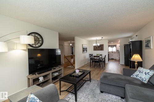 Open-concept living area featuring light wood-finish flooring, white walls, and recessed lighting - 25 1904 Mill Woods Road Road, Edmonton, AB - Indoor Photo Showing Living Room