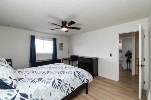 Light-toned wood-finish flooring provides a bright foundation for this room - 25 1904 Mill Woods Road Road, Edmonton, AB - Indoor Photo Showing Bedroom