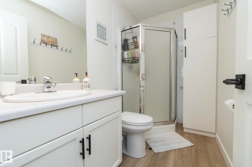 Bathroom featuring a vanity with a white countertop, oval sink, and chrome faucet - 25 1904 Mill Woods Road Road, Edmonton, AB - Indoor Photo Showing Bathroom