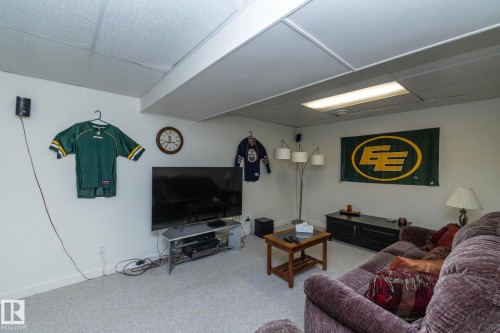 Finished lower level featuring light gray carpeting, drop ceiling with recessed lighting, and white painted walls - 25 1904 Mill Woods Road Road, Edmonton, AB - Indoor