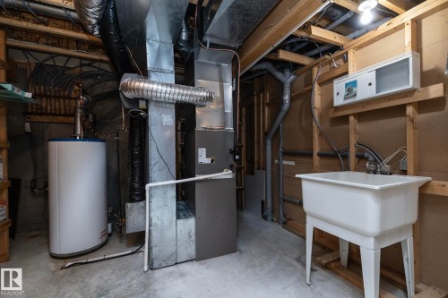 Concrete flooring with exposed ceiling joists - 25 1904 Mill Woods Road Road, Edmonton, AB - Indoor Photo Showing Basement