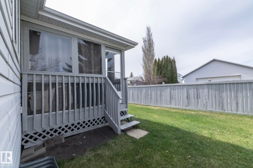 Screened-in porch featuring a railing and steps leading to a grass lawn - 25 1904 Mill Woods Road Road, Edmonton, AB - Outdoor With Deck Patio Veranda